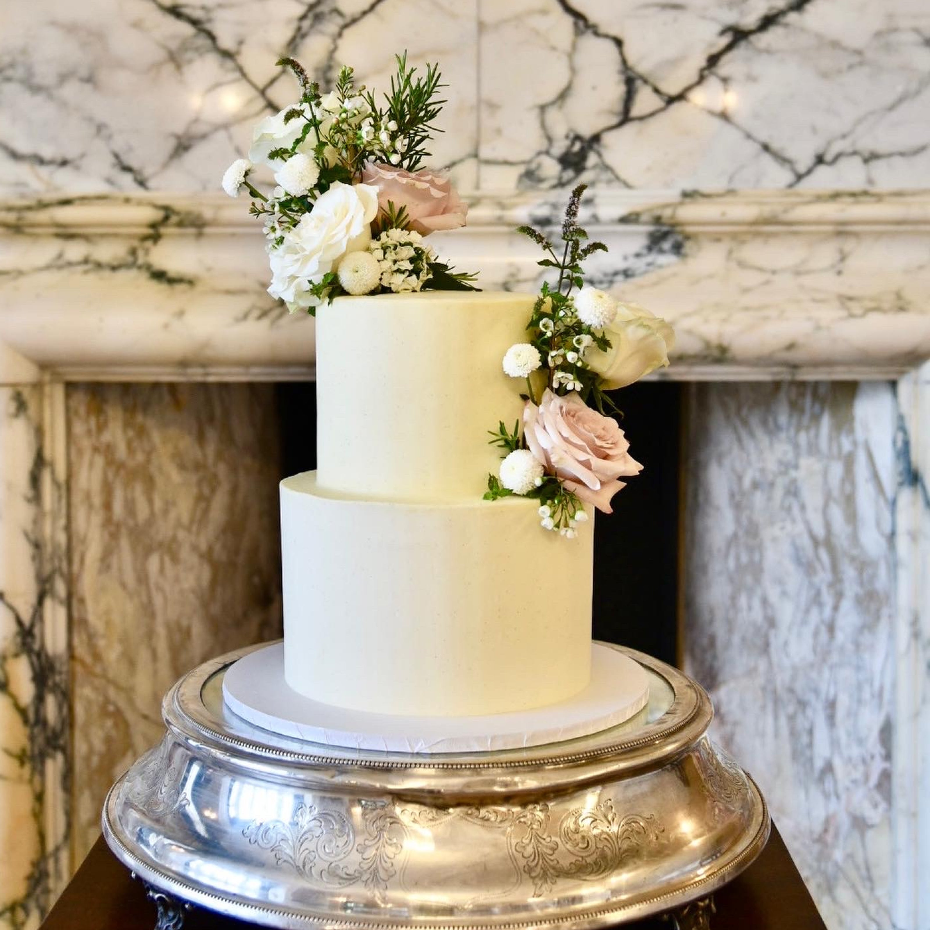 Elegant floral cake sitting on a silver cake stand